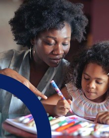 person look down at a toddler drawing a picture